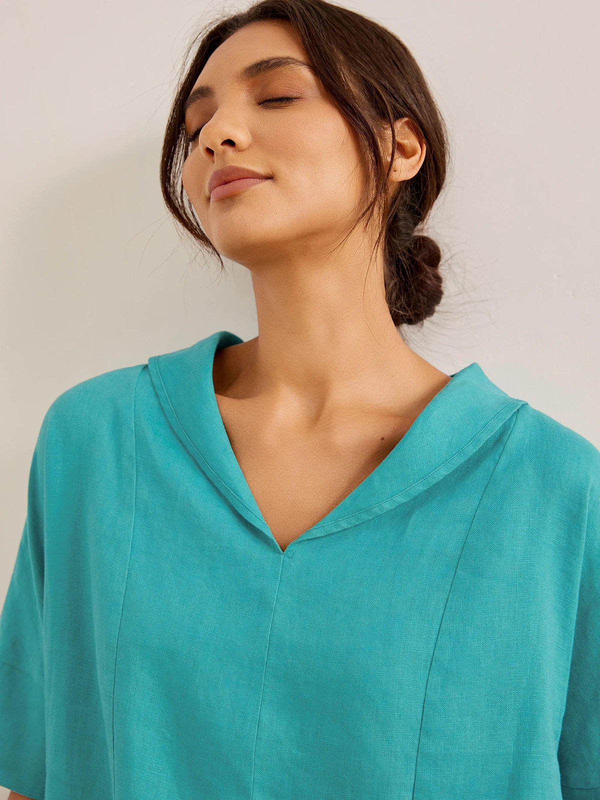 a woman with her eyes closed