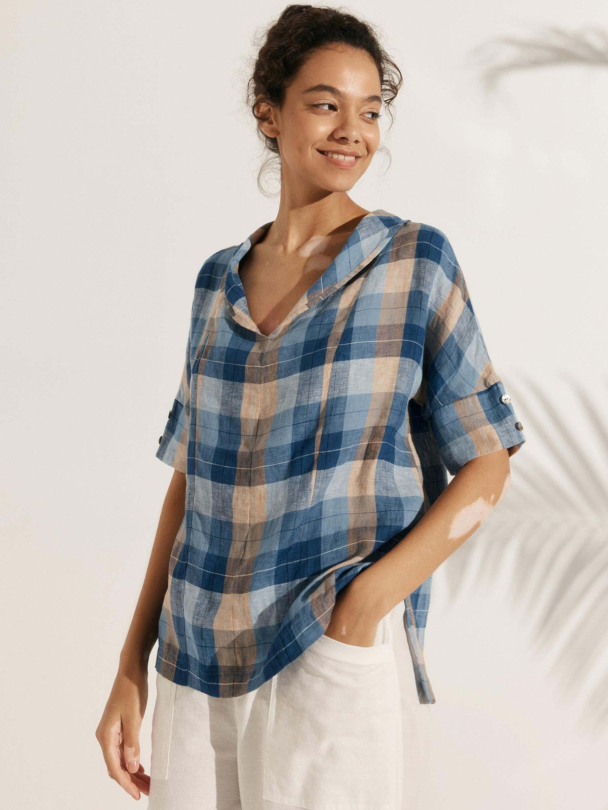 a woman in a blue plaid shirt