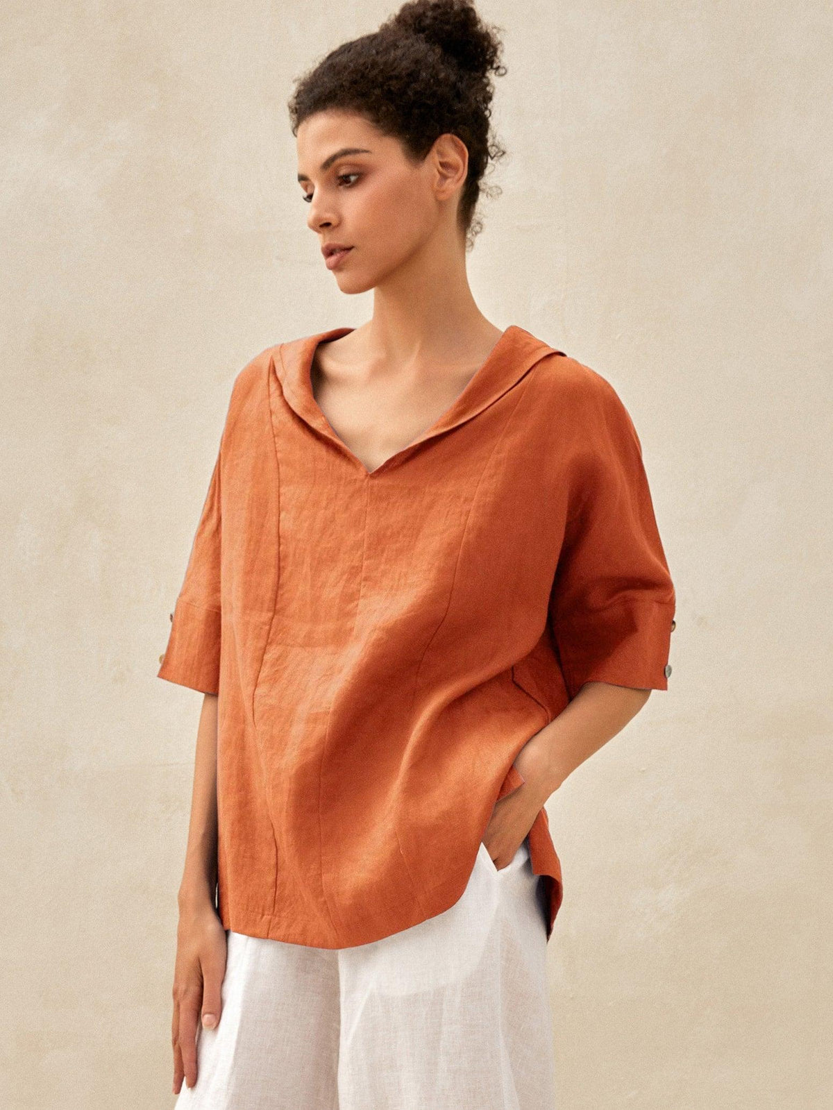 a woman in an orange shirt
