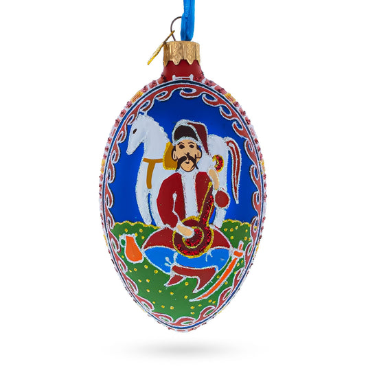 a blue and red ornament with a picture of a man playing a guitar