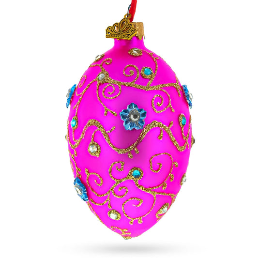 a pink ornament with gold designs