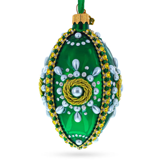 a green and gold decorated christmas ornament