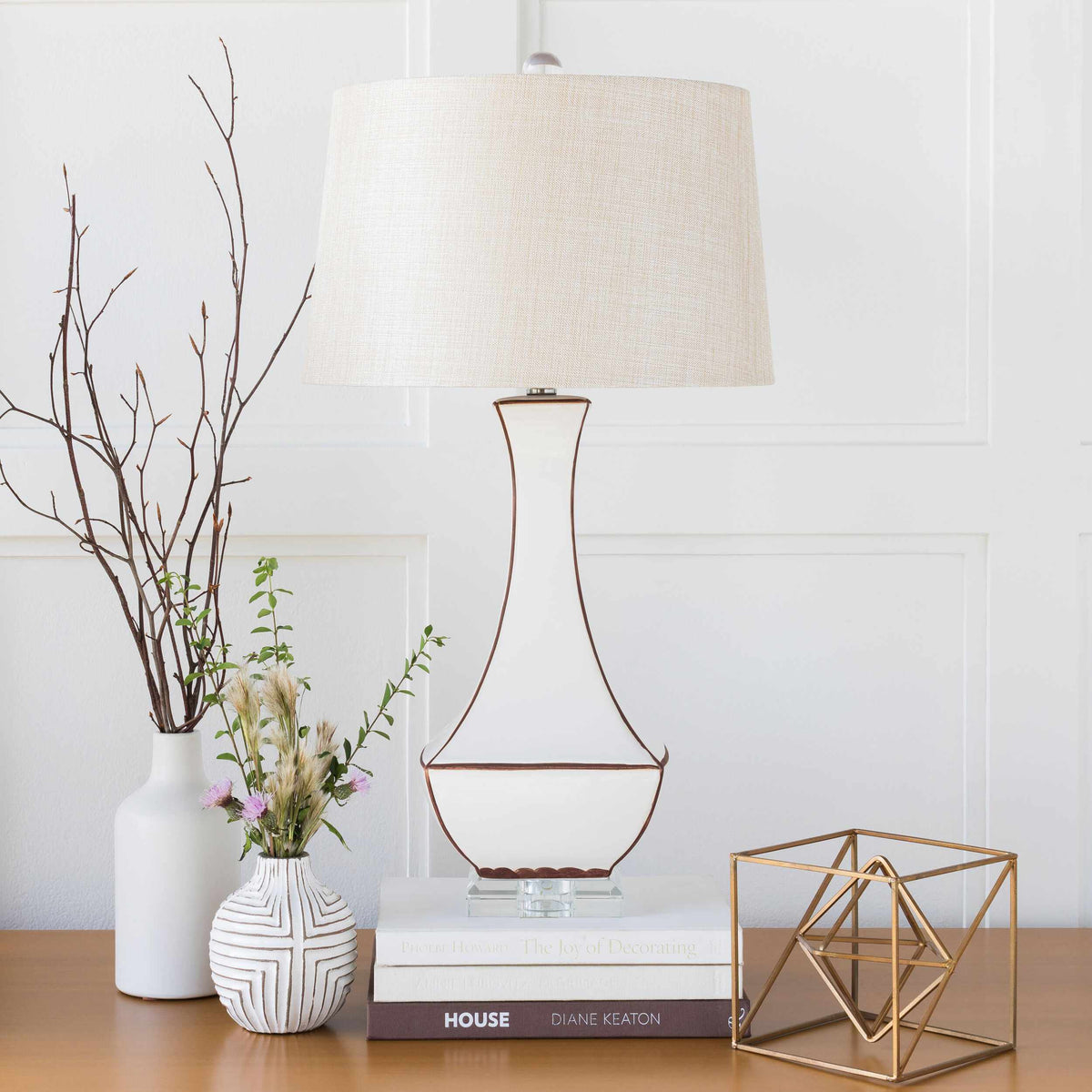 a lamp and vases on a table