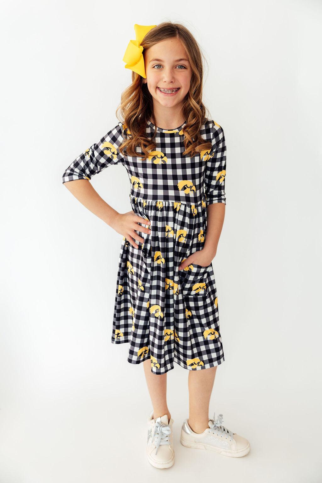 a girl in a checkered dress