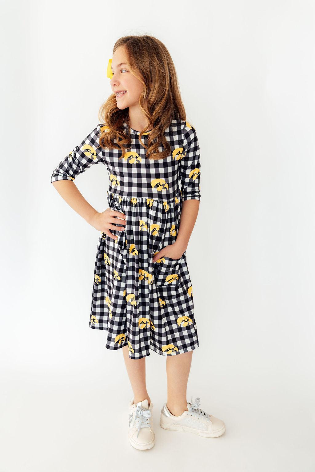 a girl in a checkered dress