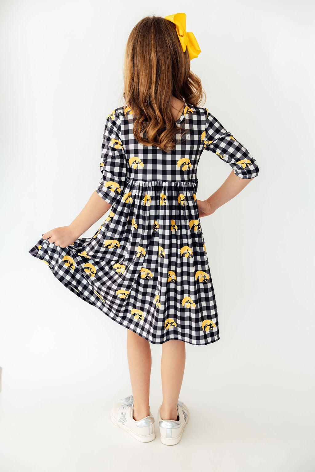 a girl in a checkered dress