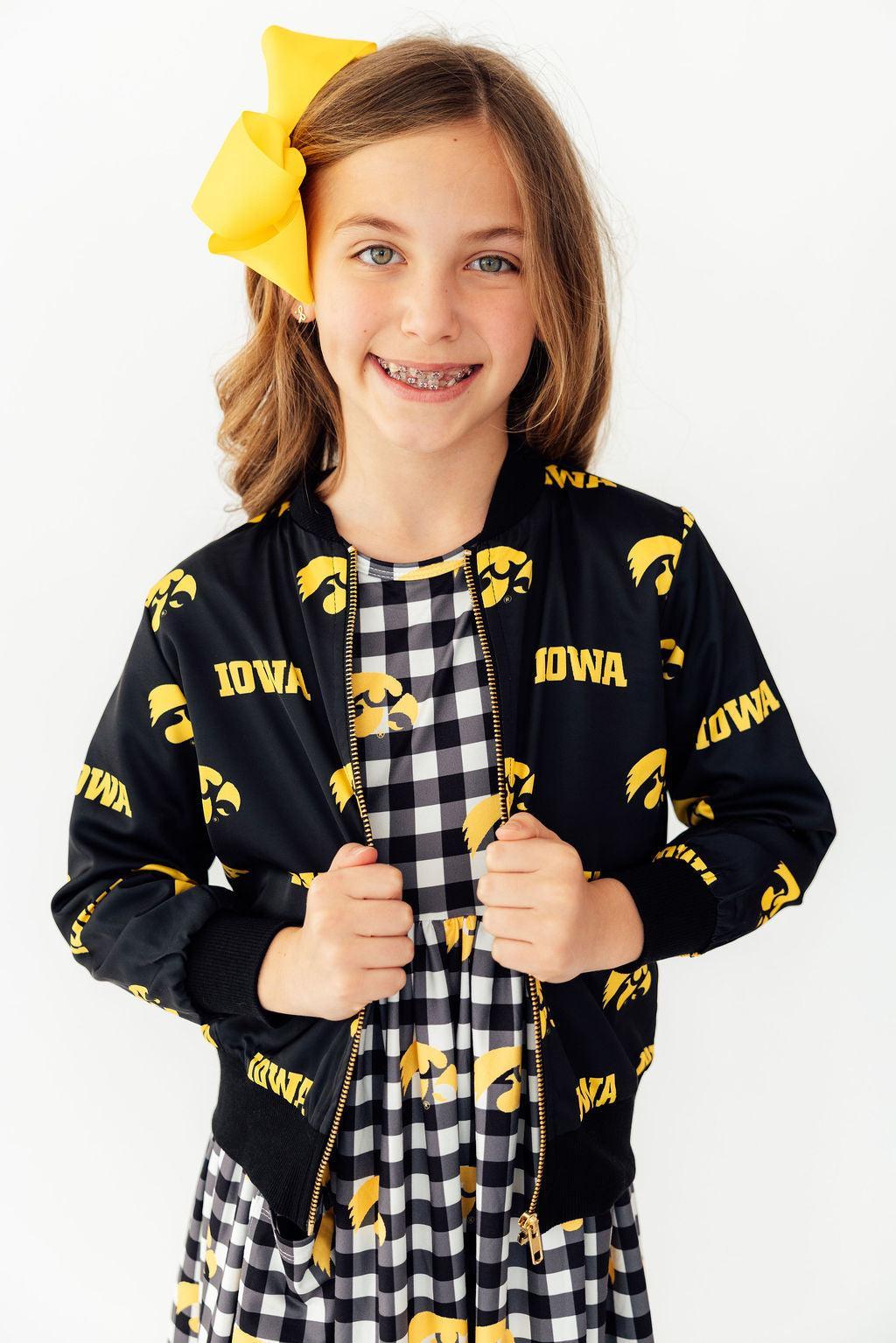 a girl with braces wearing a yellow bow on her head