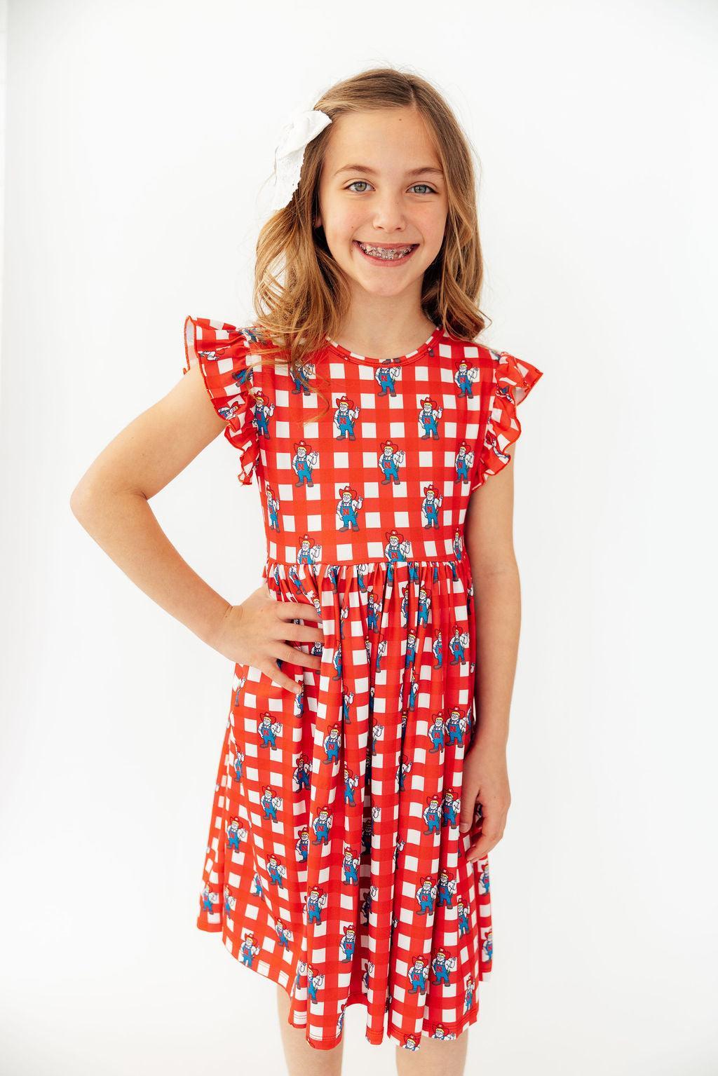 a girl in a red and white dress