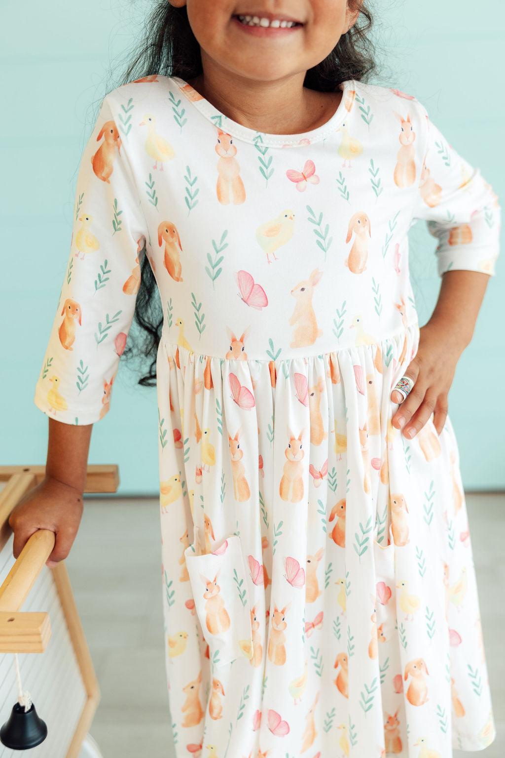 a girl wearing a dress with a bunny print