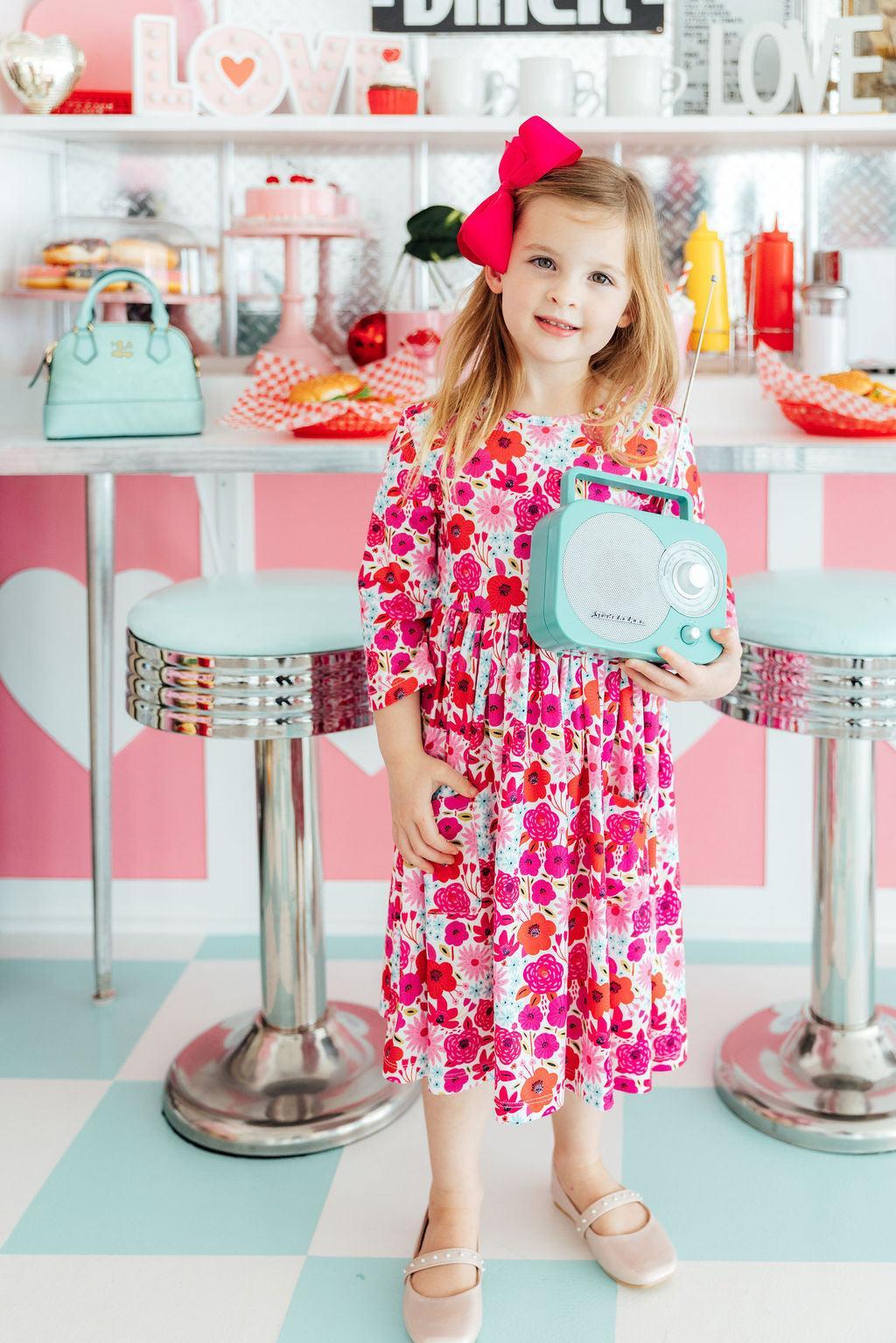 a girl holding a radio