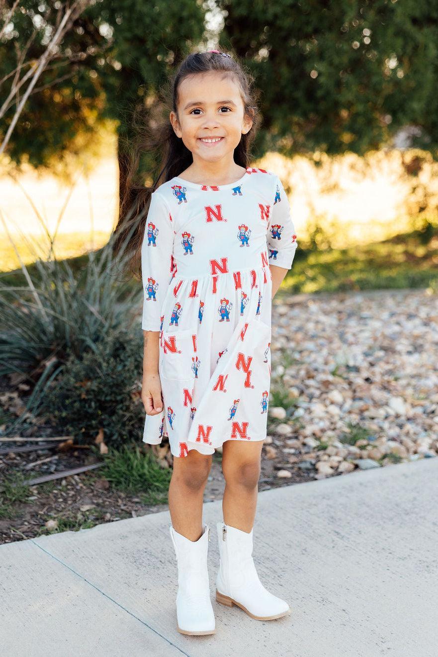 a girl standing on a sidewalk