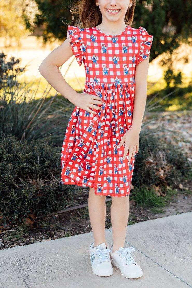 a girl in a red and white checkered dress