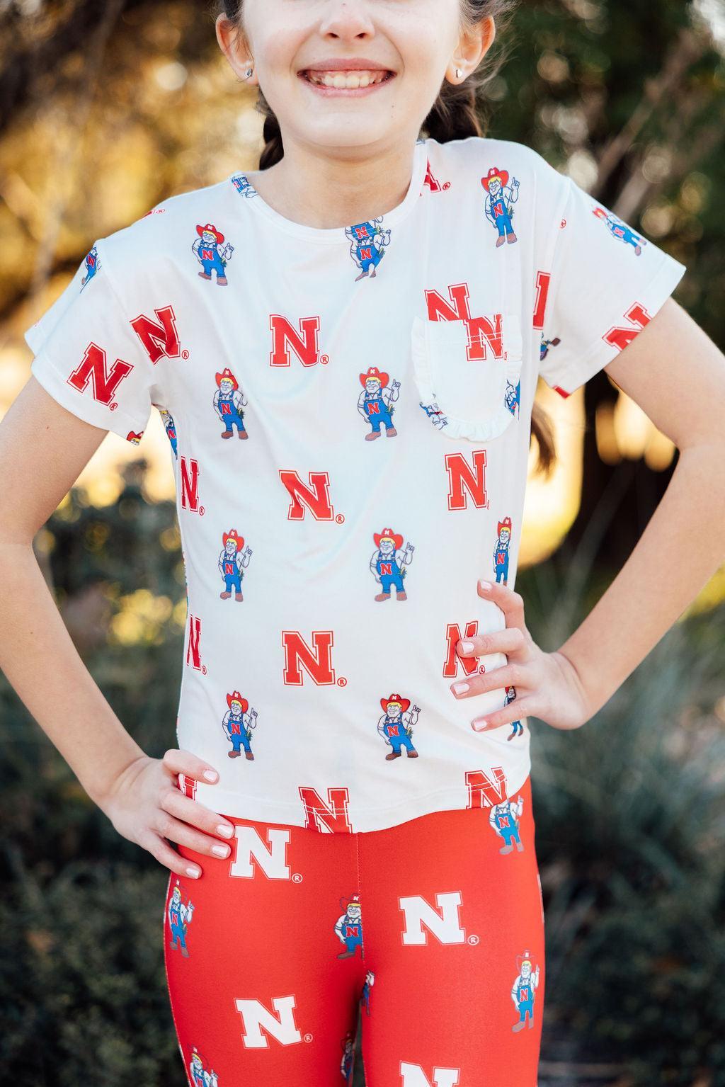 a woman wearing a t-shirt with cartoon characters on it