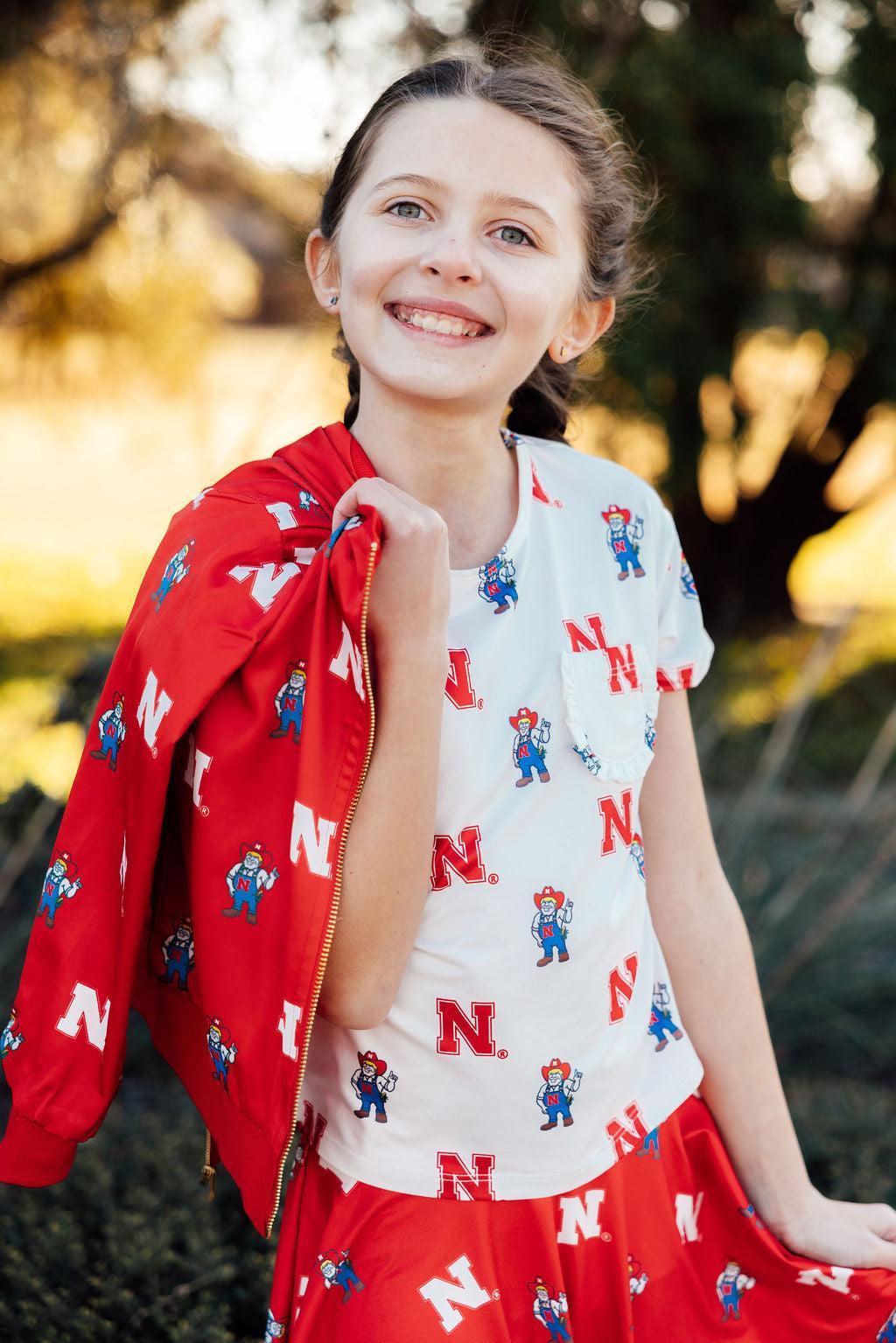 a girl smiling with a red jacket