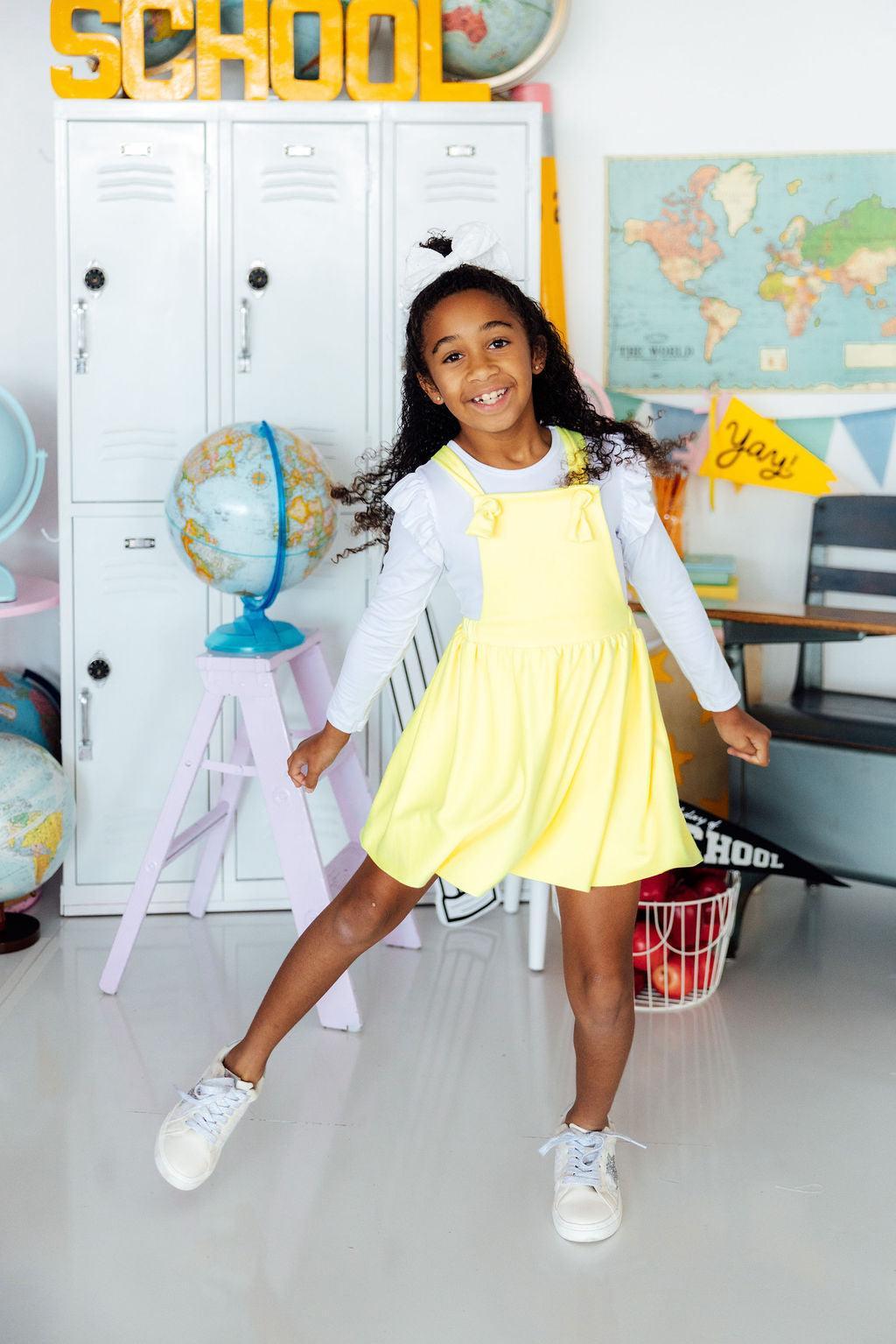 a girl in a yellow dress