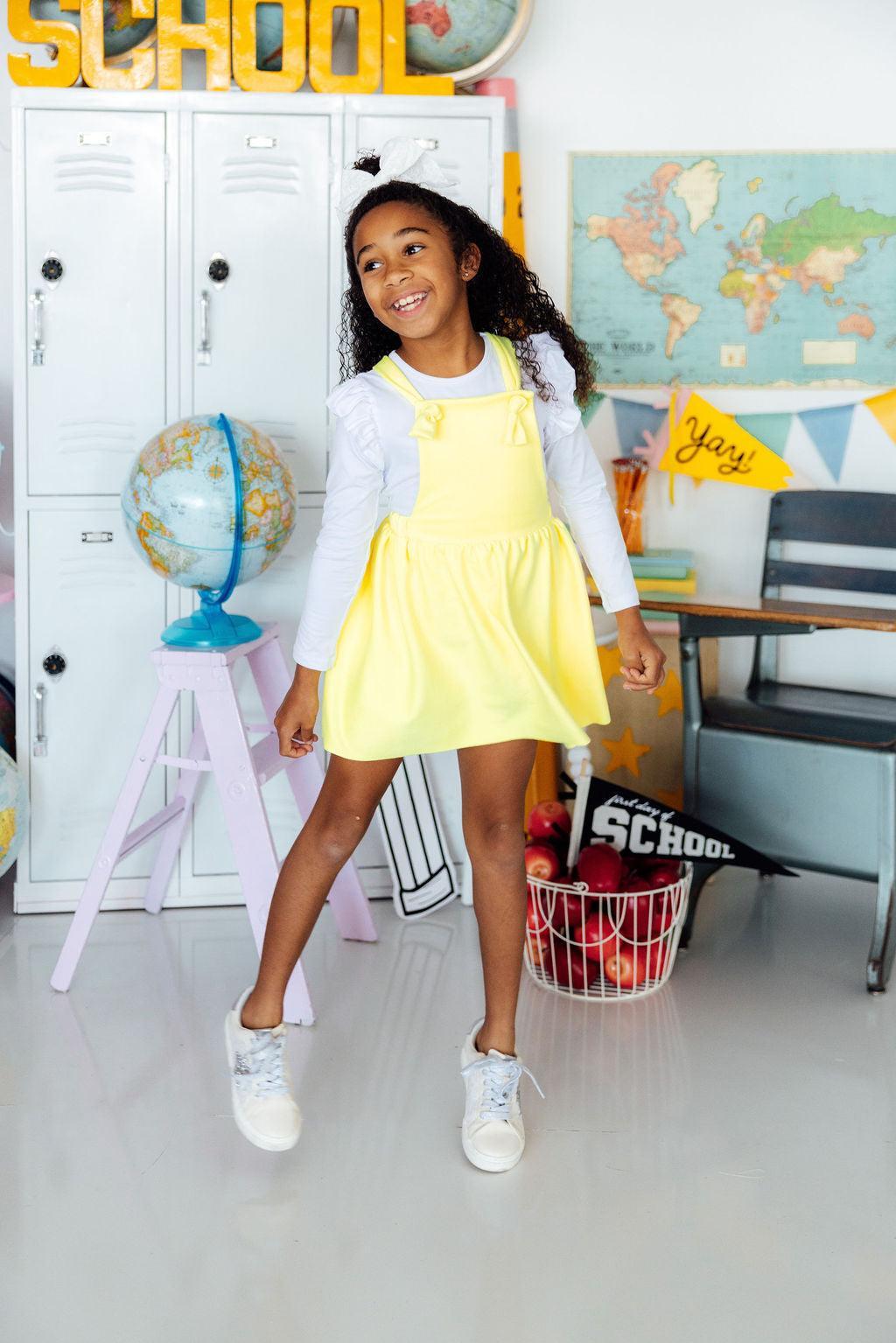 a girl in a yellow dress