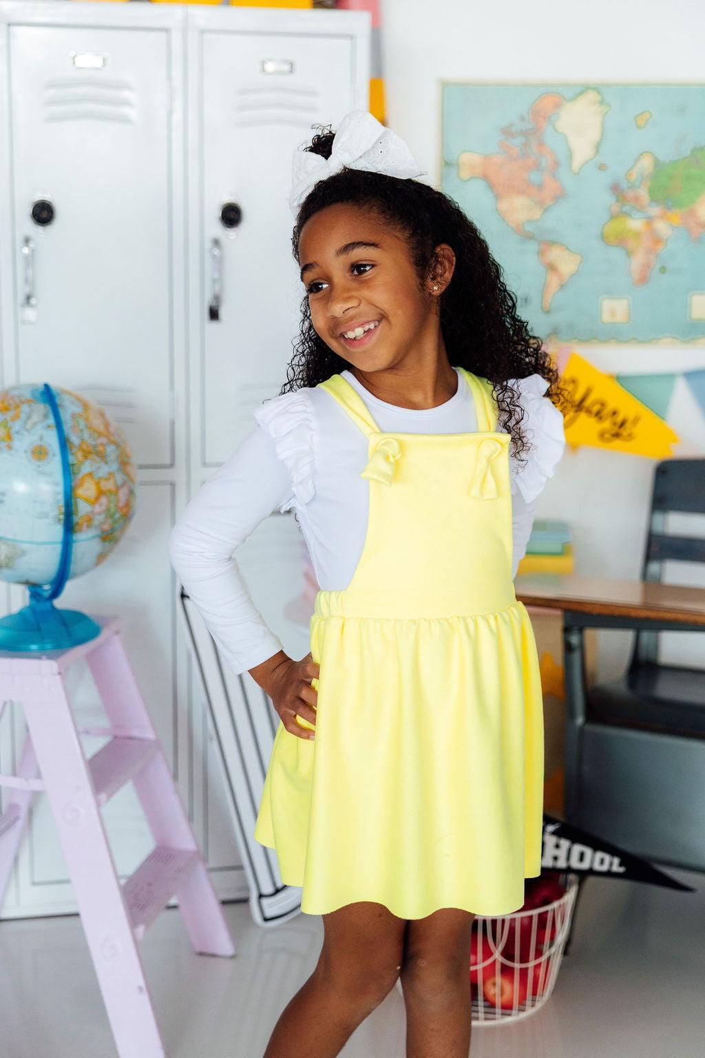 a girl in a yellow dress