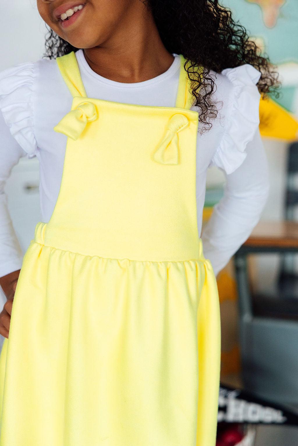 a girl wearing a yellow apron