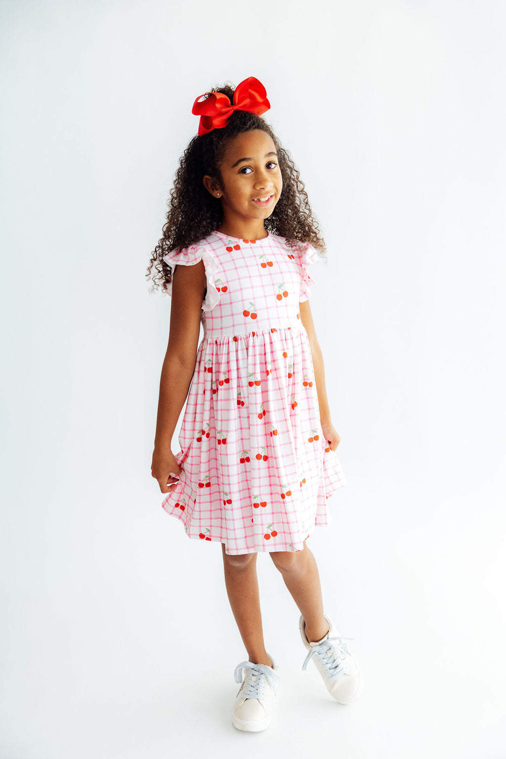 a girl in a dress and a red bow