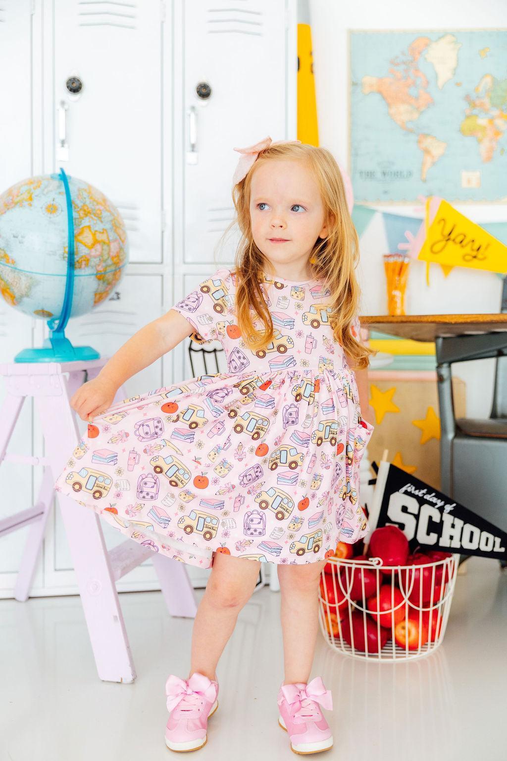 a girl in a pink dress
