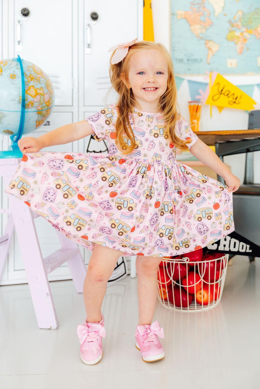 a girl in a pink dress