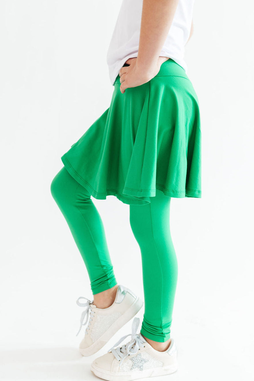 a person wearing green tights and a white shirt