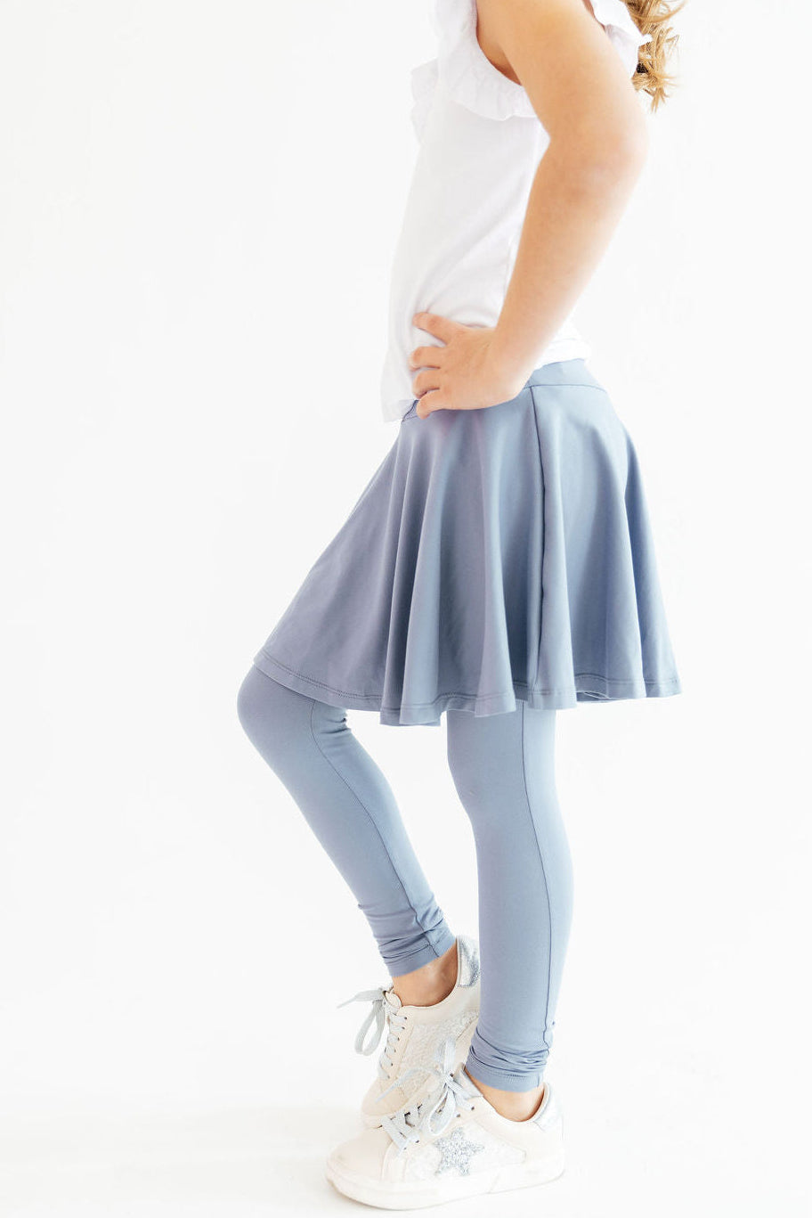 a person wearing a skirt and leggings