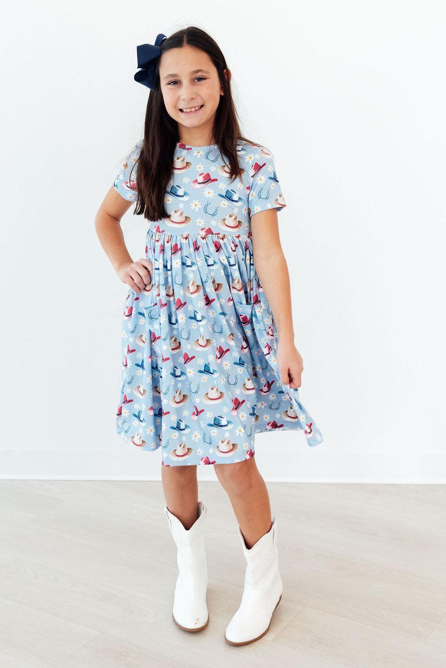 a girl in a dress and white boots