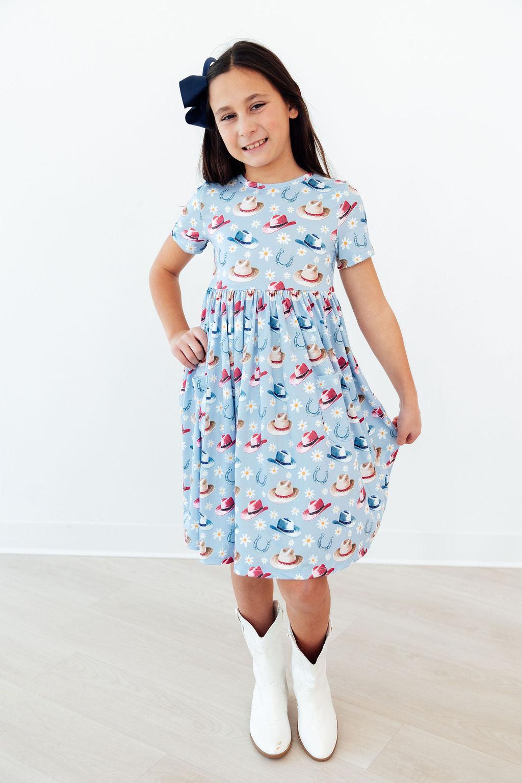 a girl wearing a dress and white boots