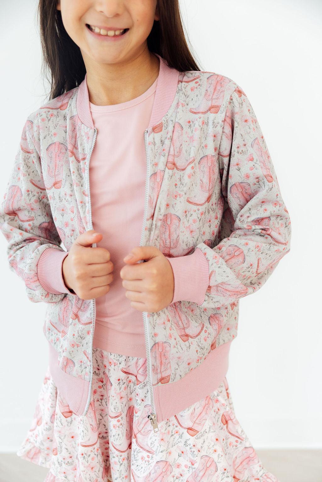 a girl wearing a pink and white pajamas