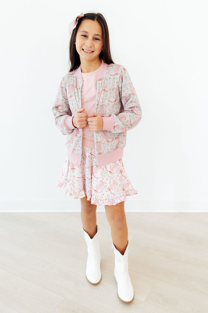 a girl in a pink and white outfit