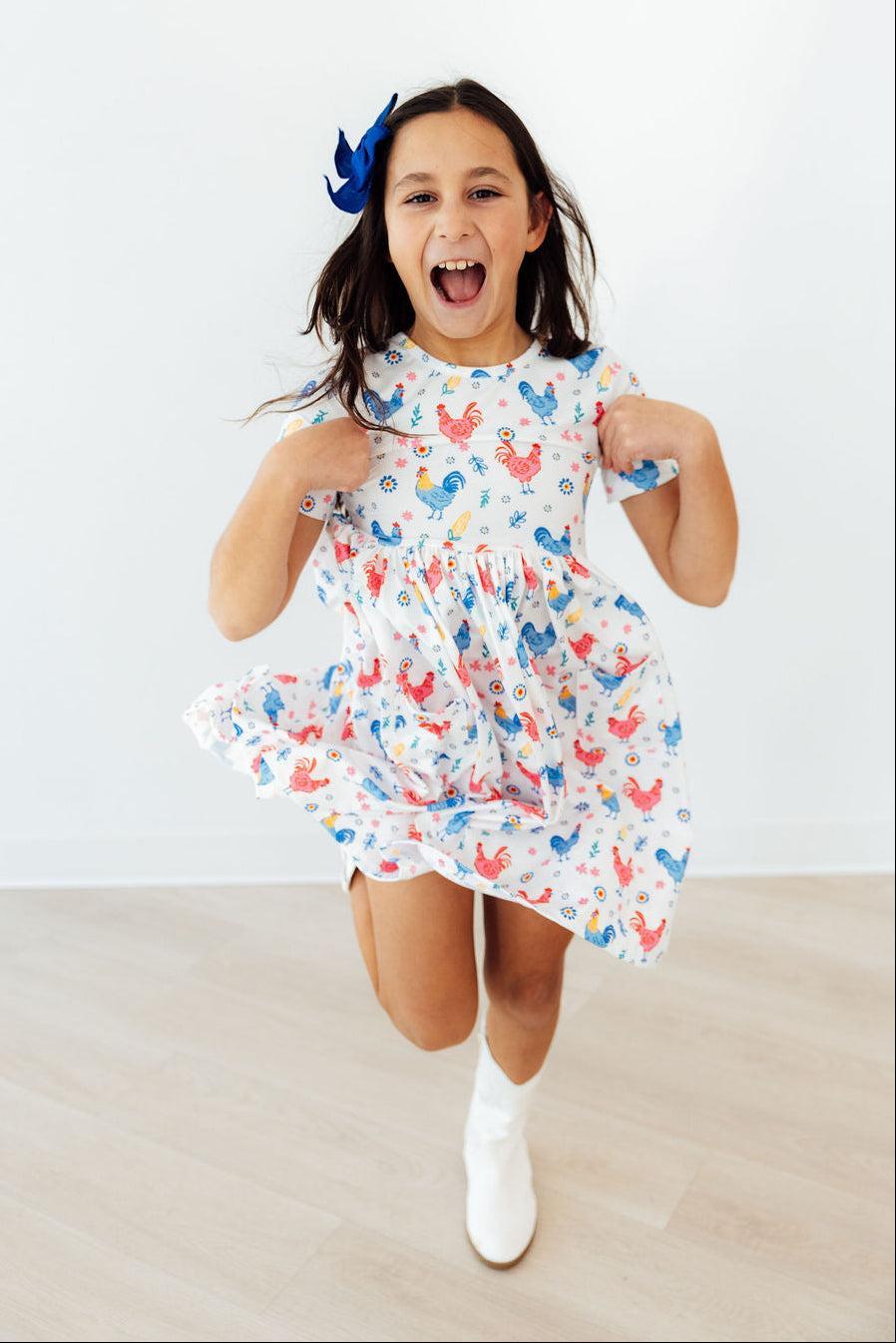 a girl jumping in a dress