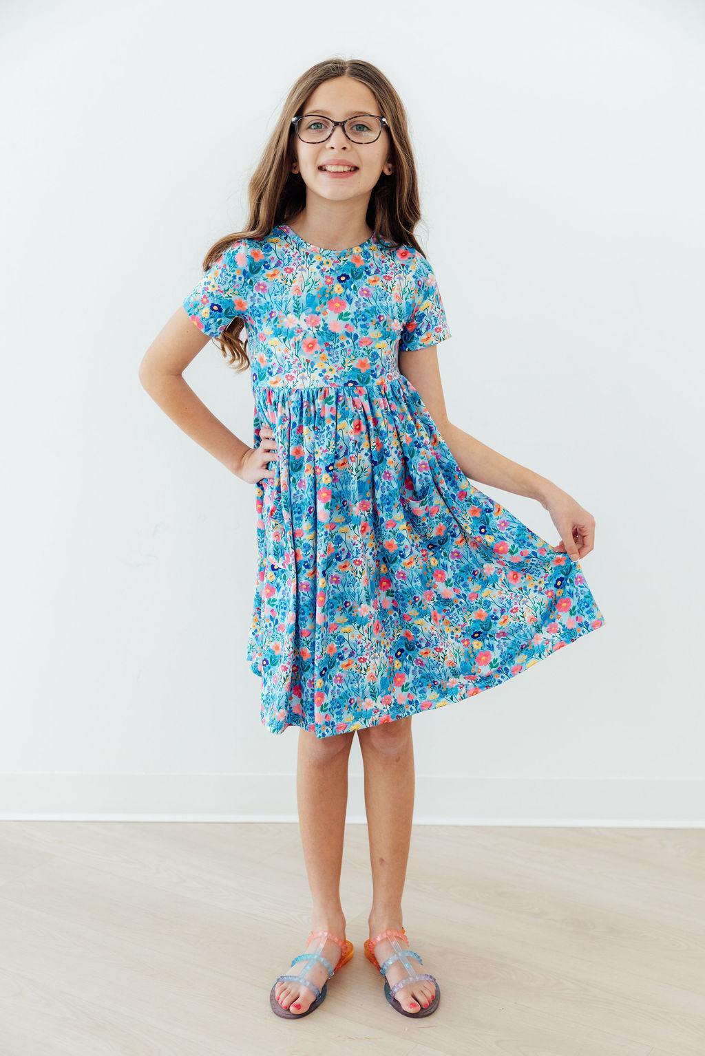 a girl in a blue dress