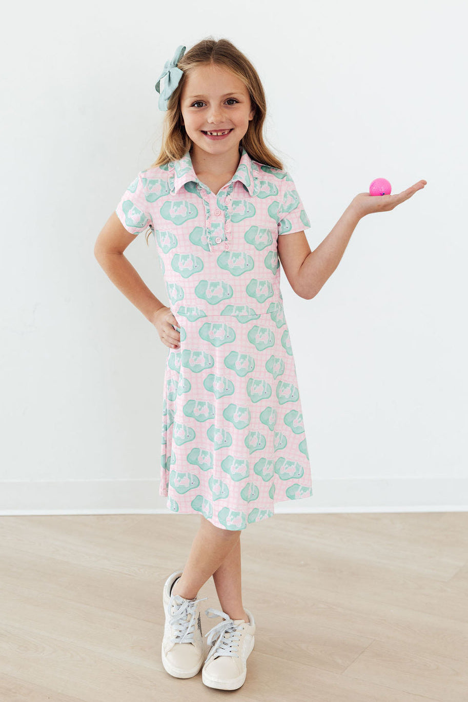 a girl holding a pink object