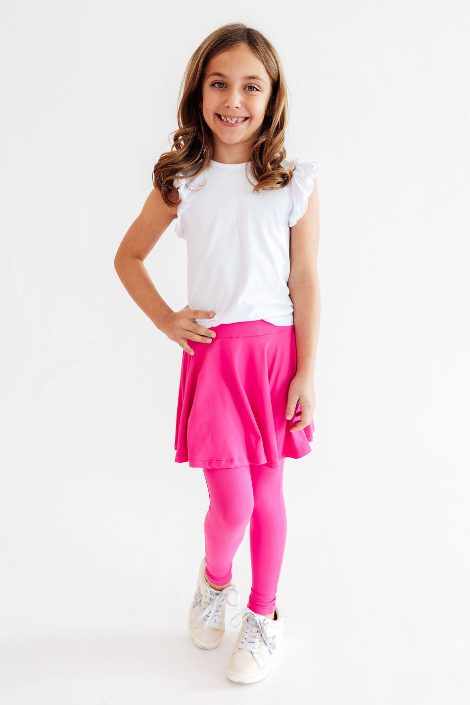 a girl in a pink skirt and white shirt