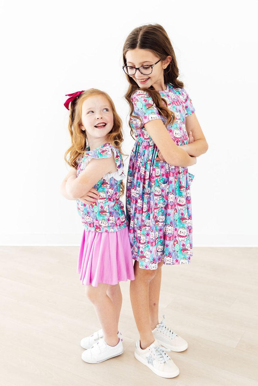two girls in dresses