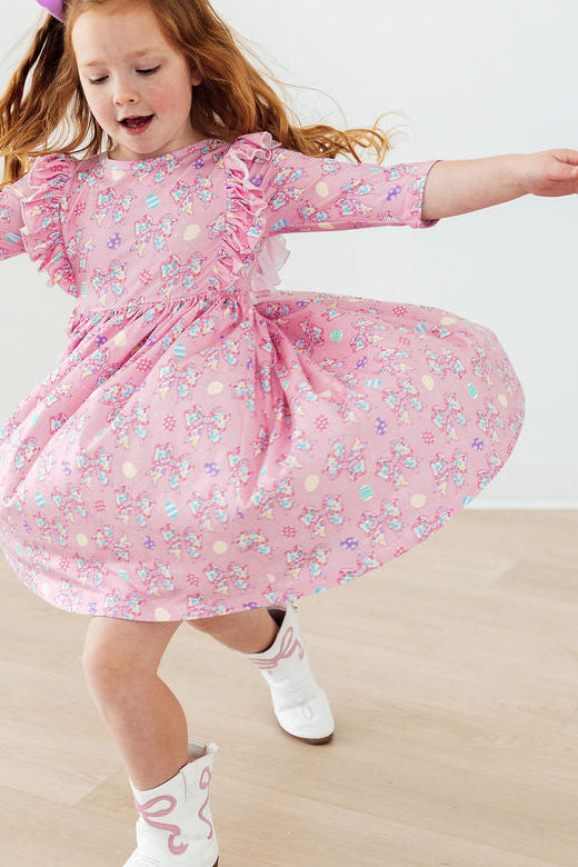 a girl wearing a pink dress and white socks dancing
