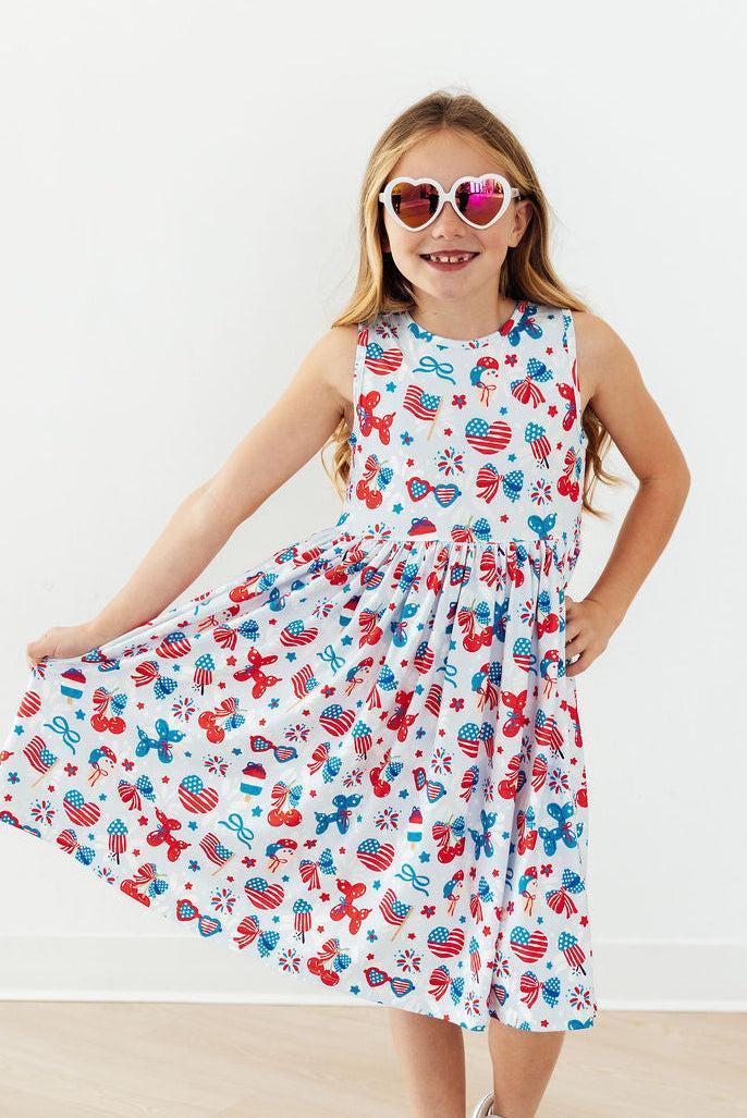 a girl wearing sunglasses and a dress