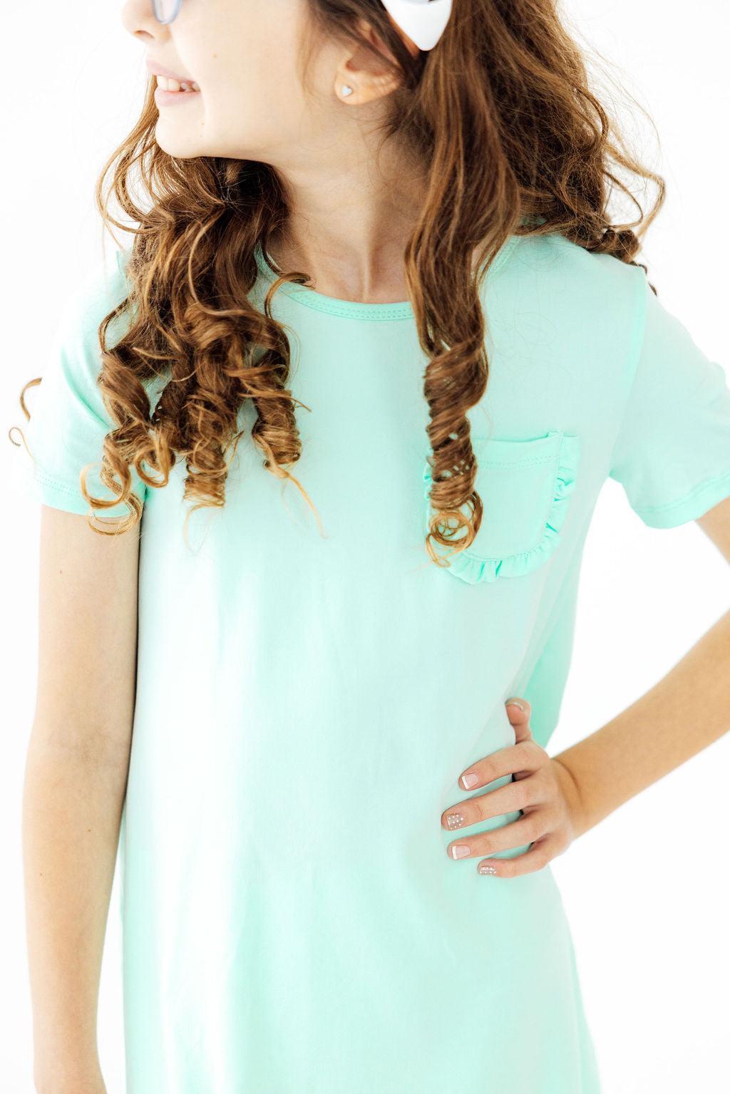 a girl with her hand on her hip