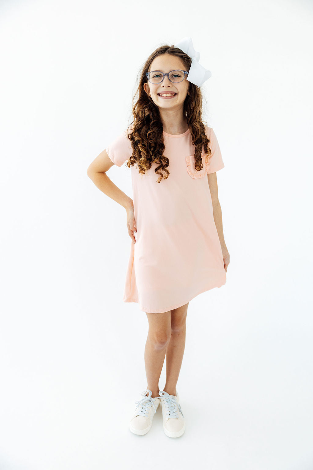 a girl wearing a pink dress and glasses
