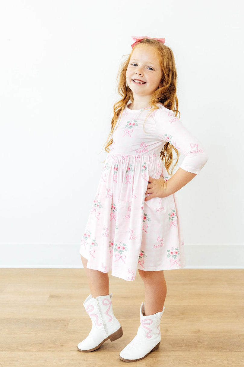 a girl in a pink dress