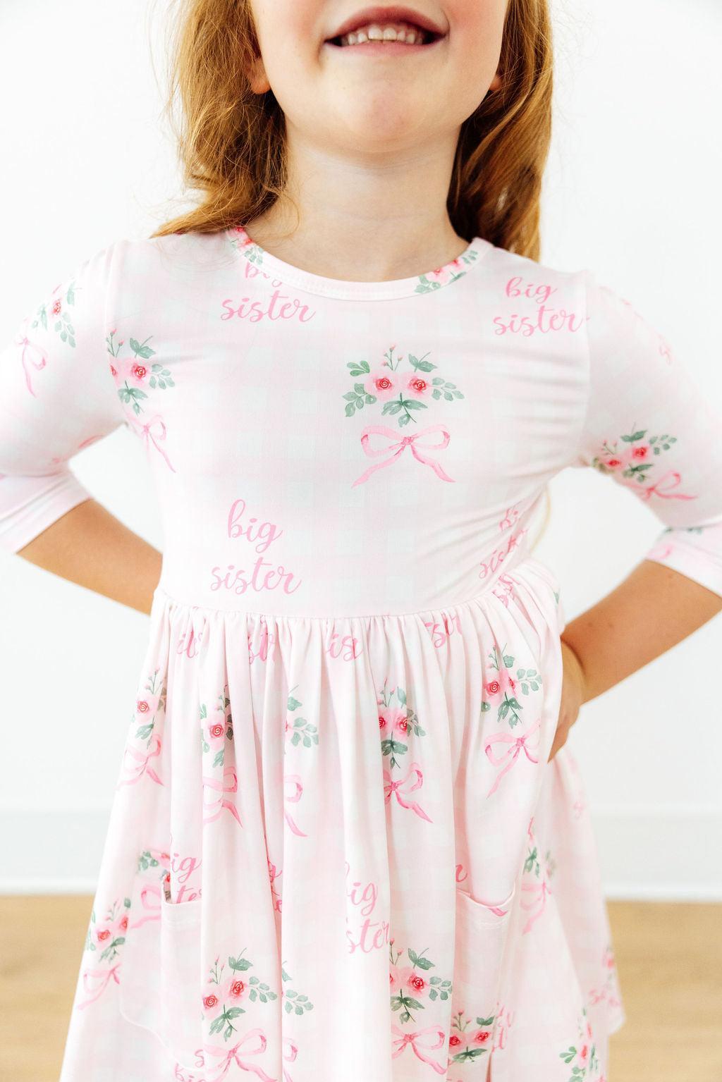 a girl in a pink dress