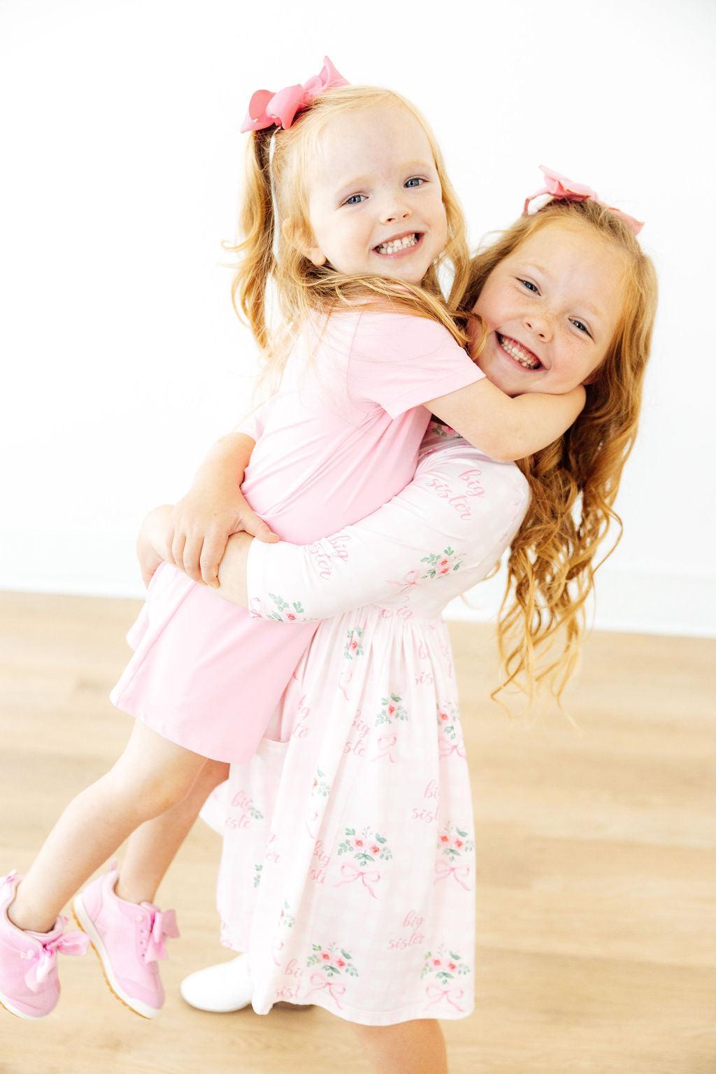 two girls hugging each other