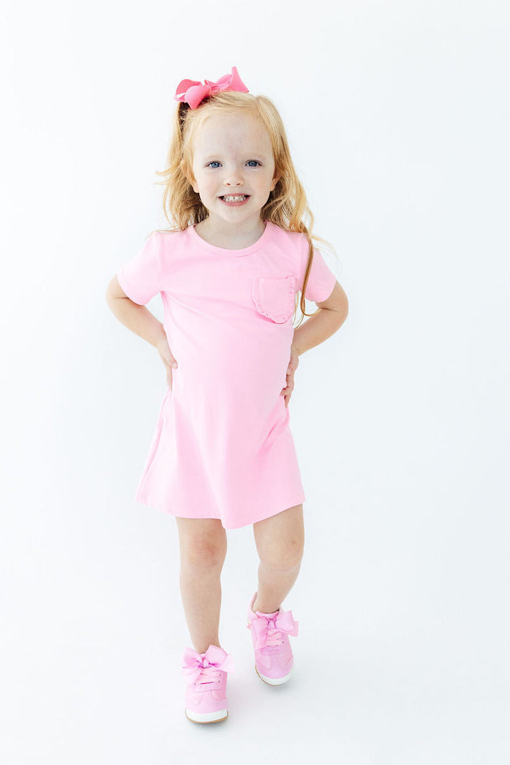 a girl in a pink dress