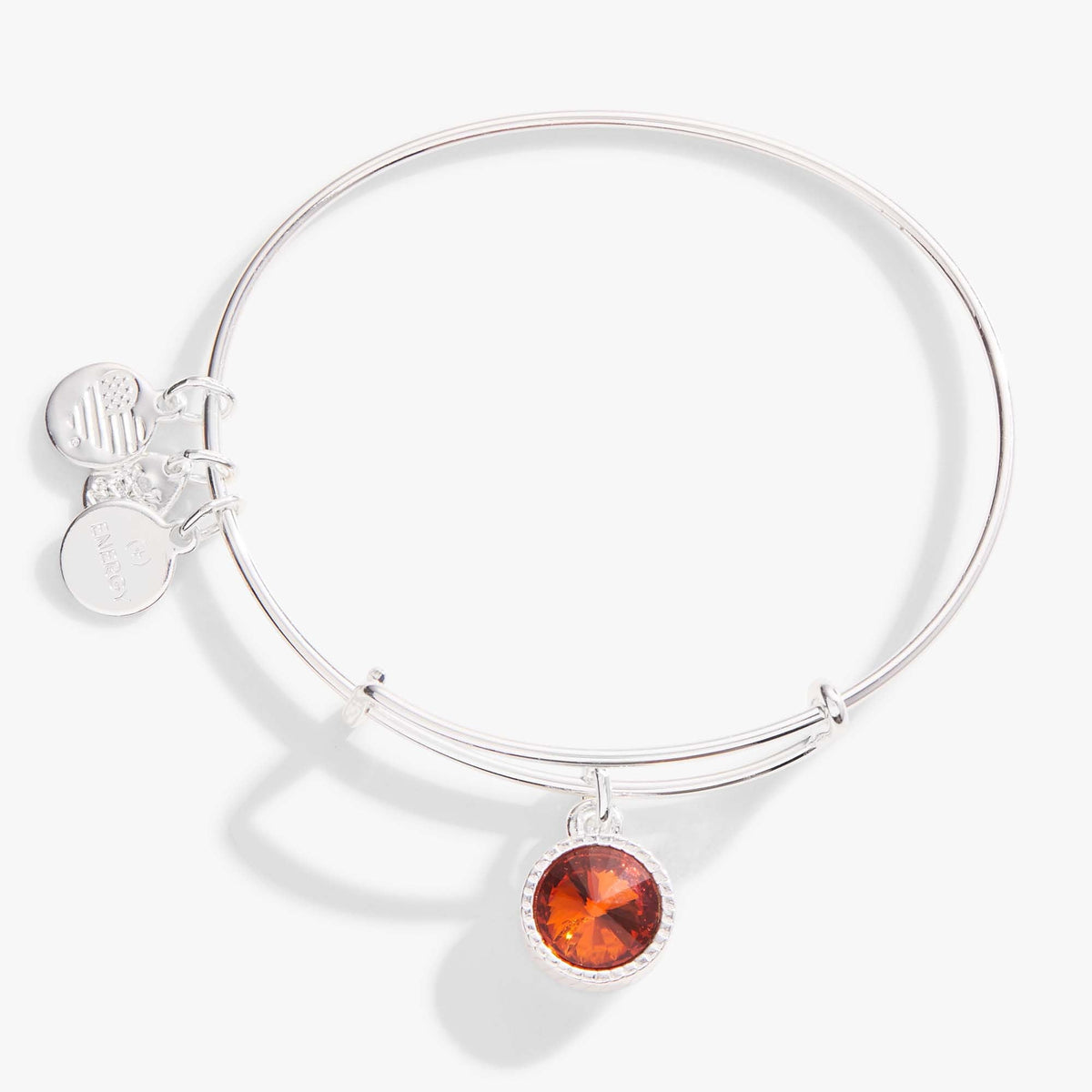 a silver bracelet with a red stone