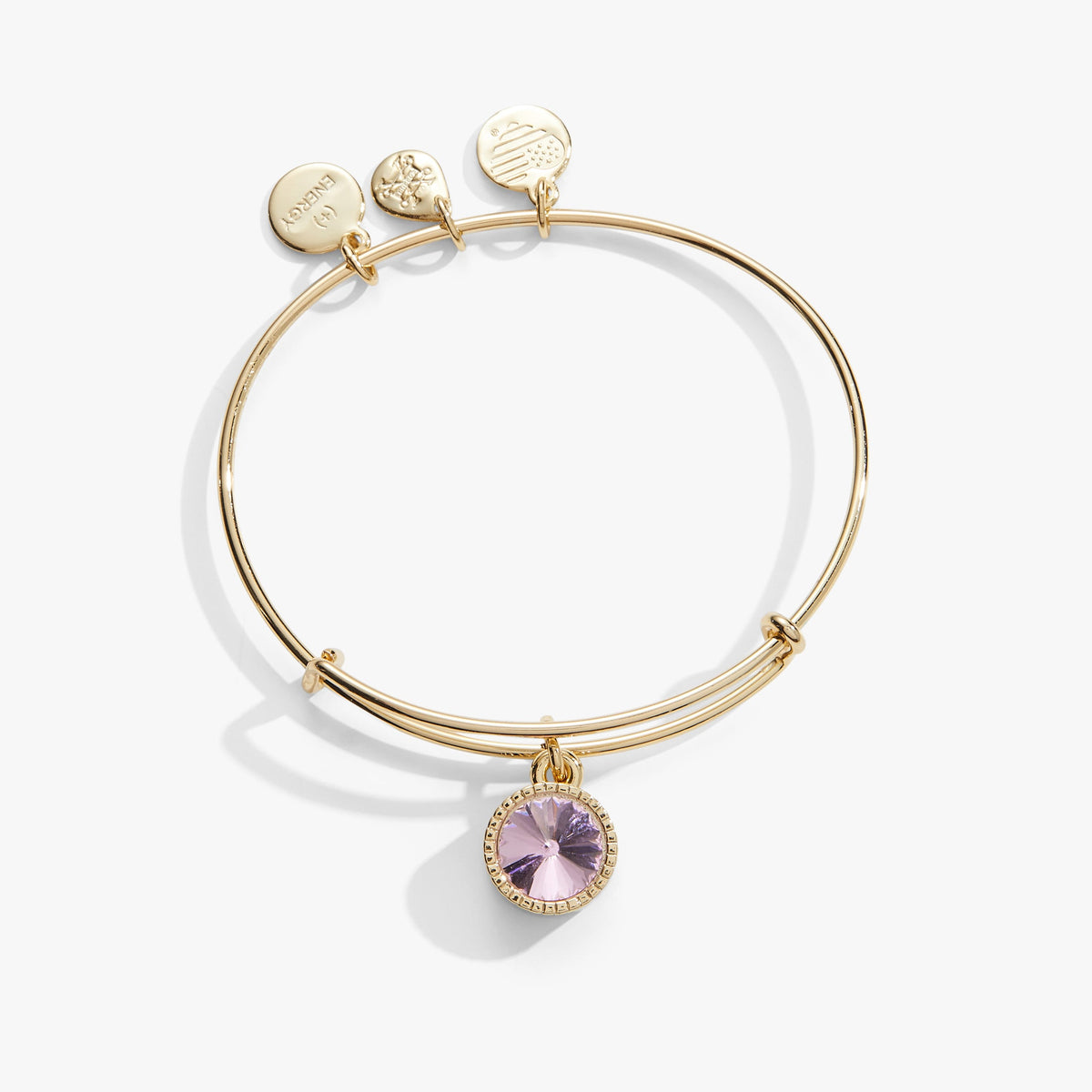 a gold bracelet with a purple stone
