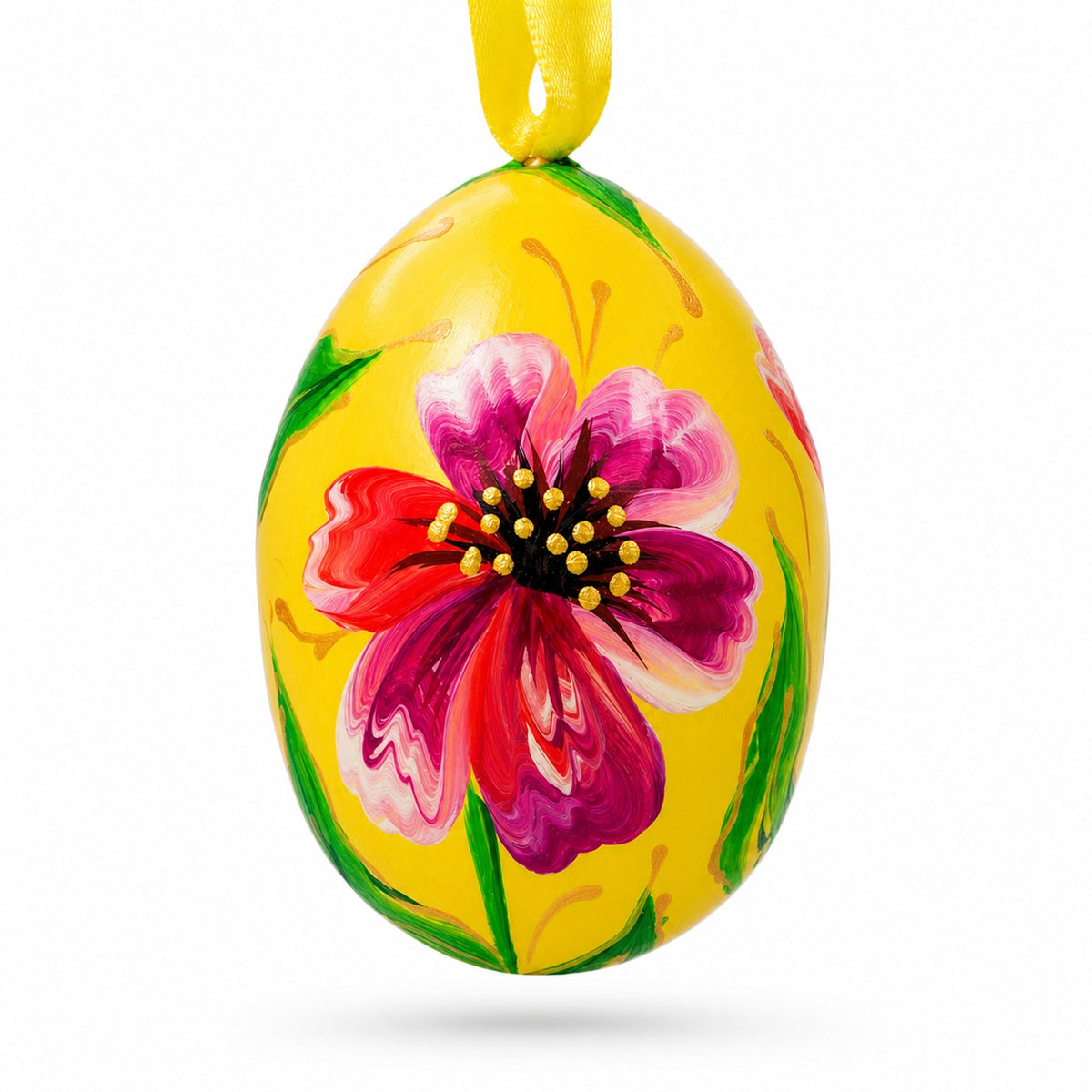 a yellow egg with a flower painted on it