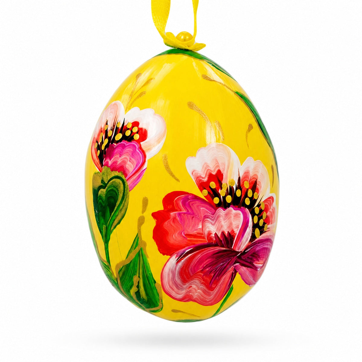 a yellow egg with flowers painted on it