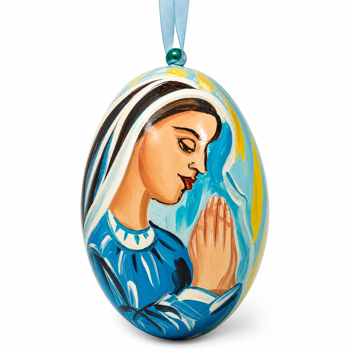 a painted egg with a woman praying