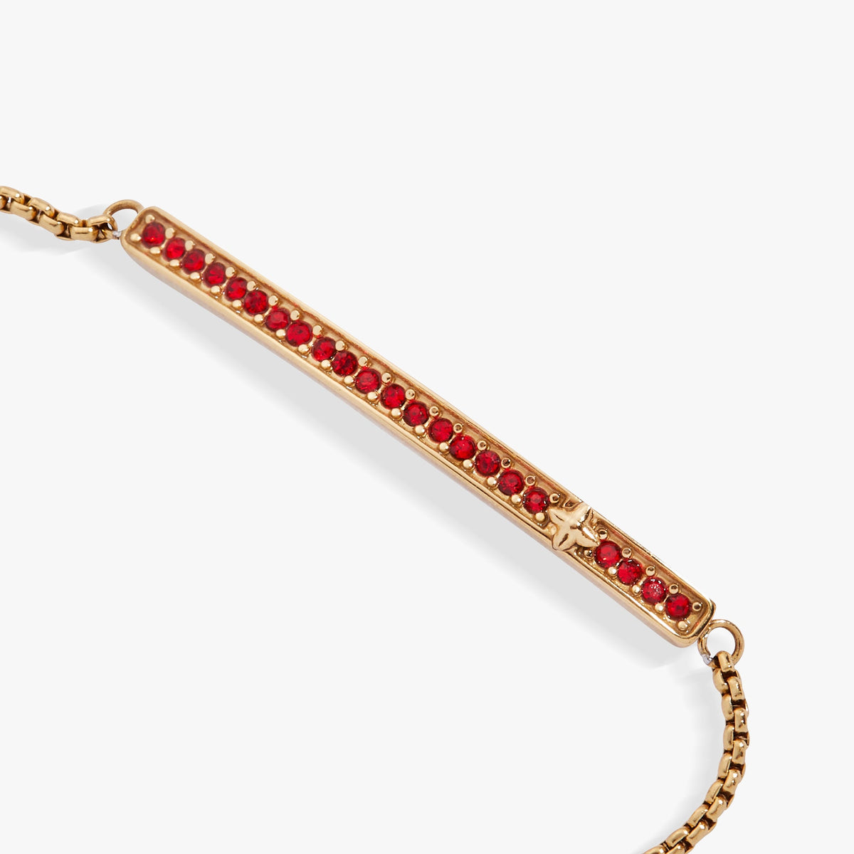 a gold bar with red stones on it